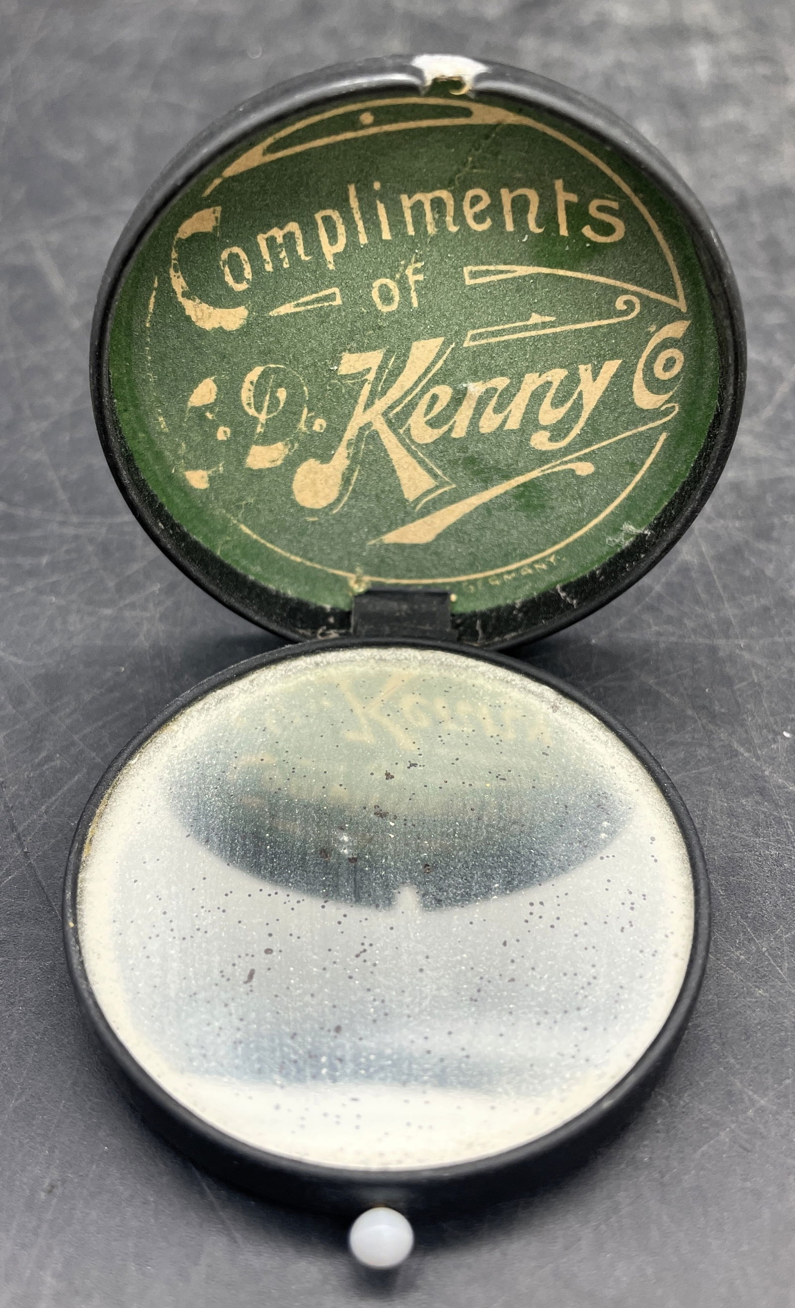 Early 1900's C D KENNY Co. Flip-lid Pocket Mirror Advertising Compact: Date/Period: approx early 1900'sDimension: approx 2" diamMaterial: mixed materialsAdditional Information: Early 1900's C D KENNY Co. Flip-lid Pocket Mirror Advertising Compact Shipping:Domestic: