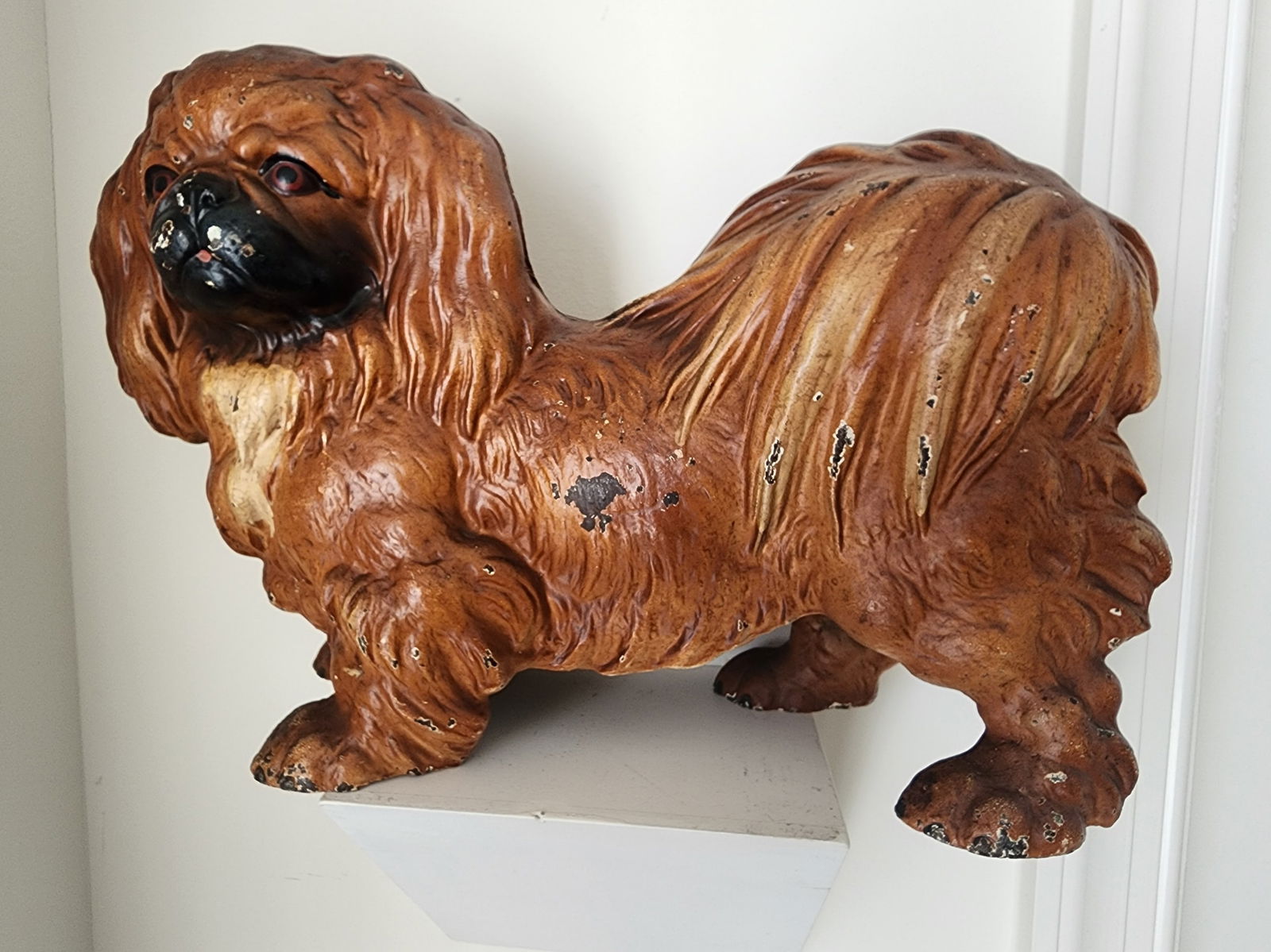 DOORSTOP IN THE FORM OF A PEKINGESE: CAST IRON MADE BY HUBLEY, LANCASTER, PA.C.1920-30. IN GOOD ORIGINAL CONDITION. NO REPAINT OR REPAIRS. WEIGHS 13 LBS. 14 INCHES LONG.SOME MINOR CHIPS AND WEAR BUT OVERALL IN VERY GOOD ORIGINAL