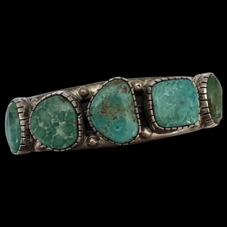 Vintage Navajo Turquoise Cuff Old Pawn: A handcrafted 45g sterling silver Native American cuff featuring natural turquoise stones in a row setting. Shipping:Domestic: Flat-rate of $20.00 to anywhere within the contiguous