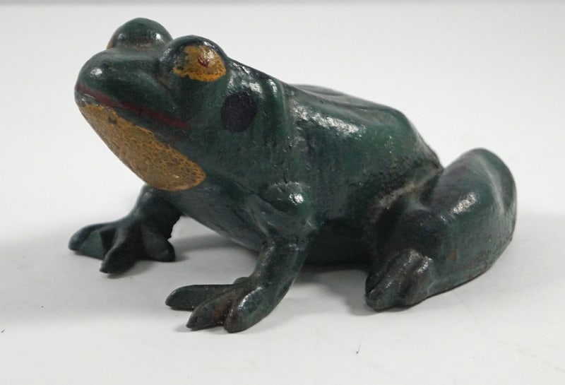 Antique Frog Cast Iron Doorstop: Title: Antique Frog Cast Iron DoorstopDimension: 3” tall x 4 3/8” wide x 5 3/4” long.Date: Ca. 1930’s.Additional Information: Full-figure, solid casting Antique cast iron Frog