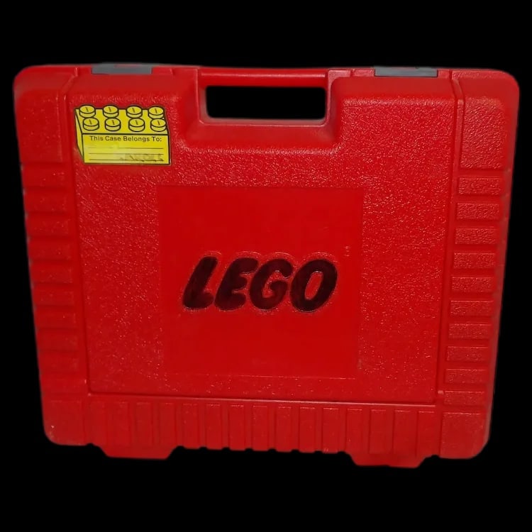 1985 Red LEGO Carry Case Loaded with Vintage Large Building Bricks!: Vintage red LEGO carry case from 1985 containing 45 large building bricks and a 2” x 6” Duplo Train Chassis. Bricks have been painted black. Measures 15” x 12” x 4”. 