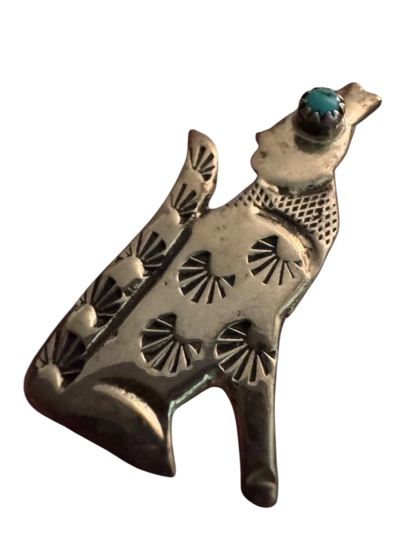 Vintage Sterling Silver Navajo Coyote Turquoise Pin Pendant Signed Sterling: This vintage Sterling Silver Navajo Coyote Turquoise Pin Pendant is a unique piece of jewelry that showcases Native American craftsmanship. The piece features a blue turquoise stone in an oval shape,