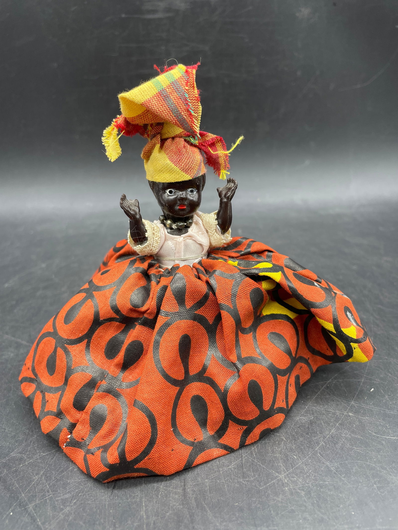 Black Lady in Red Dress Doll: Date/Period: unknownDimension: Approx 5 x 5Material: the body appears to be plastic or similarAdditional Information: Black Lady in Red Dress Doll Shipping:Domestic: Flat-rate of $8.00 to anywhere