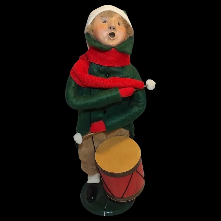 Byers’ Choice 1989 Little Drummer Boy Green Coat: Vintage 1989 caroler figure of the Little Drummer Boy wearing a green coat and brown knickers. Signed on the base, stands 9 ½” tall. Shipping:Domestic: Flat-rate of $15.00 to anywhere