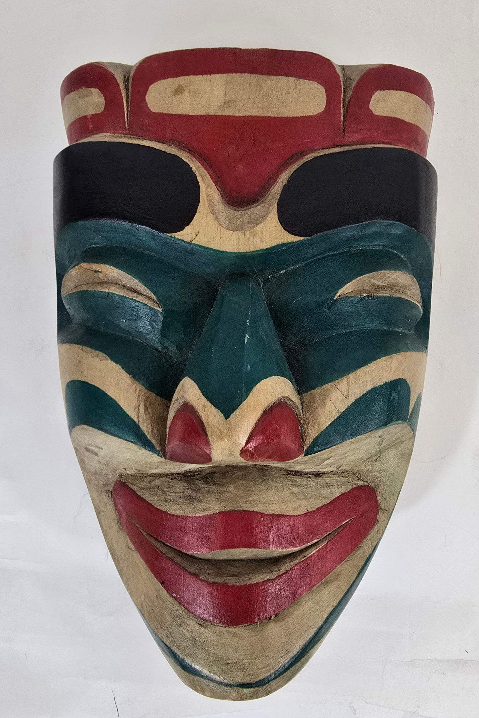 Haida mask: Title: Haida maskDimension: 10" x 7" x 5"Description: Haida carved and painted mask by Carl Simeon a Kwakwaka'waka carver. Ca late 20th century. Carved and painted cedar wood in mint condition. 