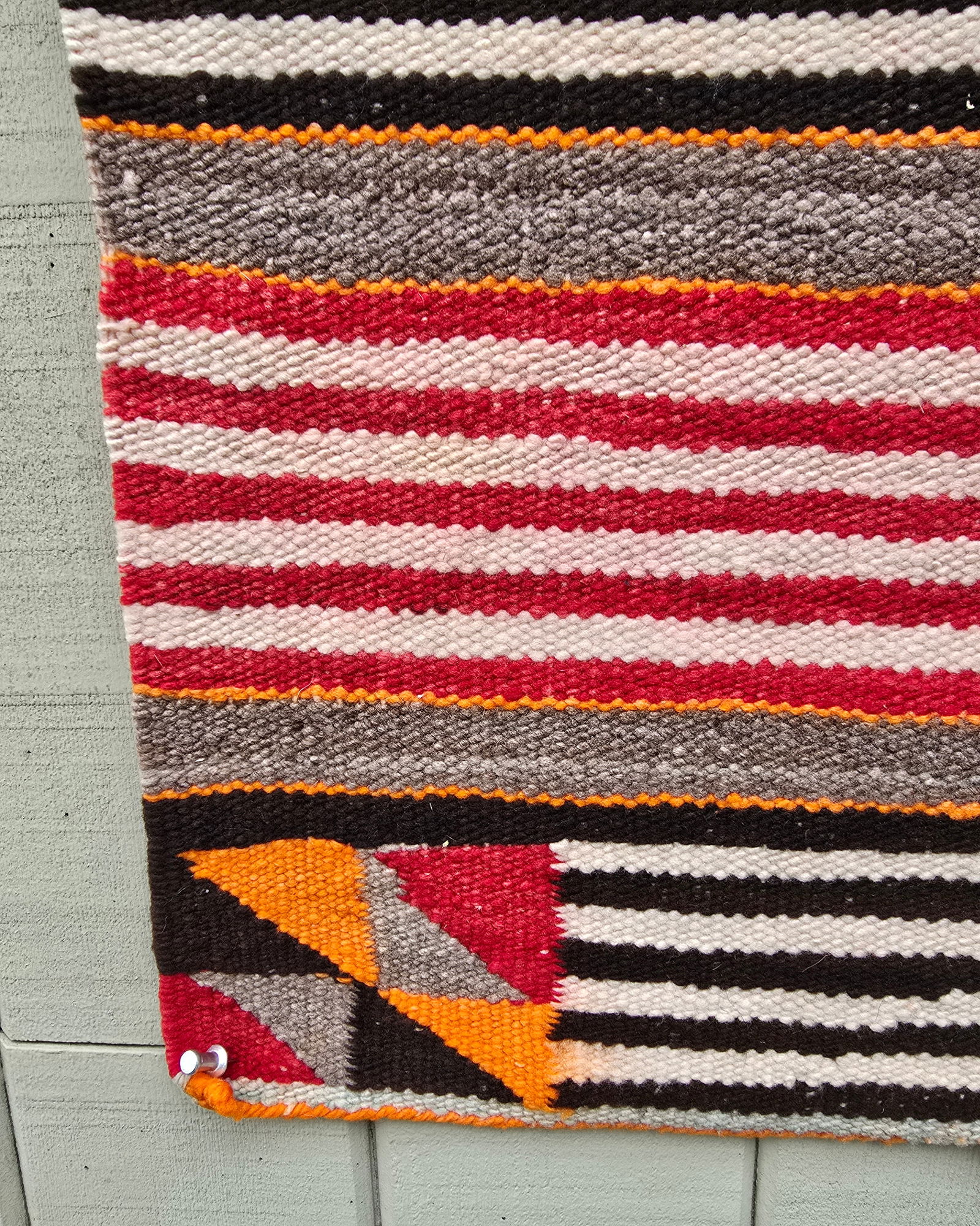 Navajo saddle blanket: Title: Navajo saddle blanket Dimension: 29.25" x 29.75" Description: Navajo woven banded saddle blanket with modified whirling log corner blocks ca 1930s or 1940s. Excellent condition. A good wall han