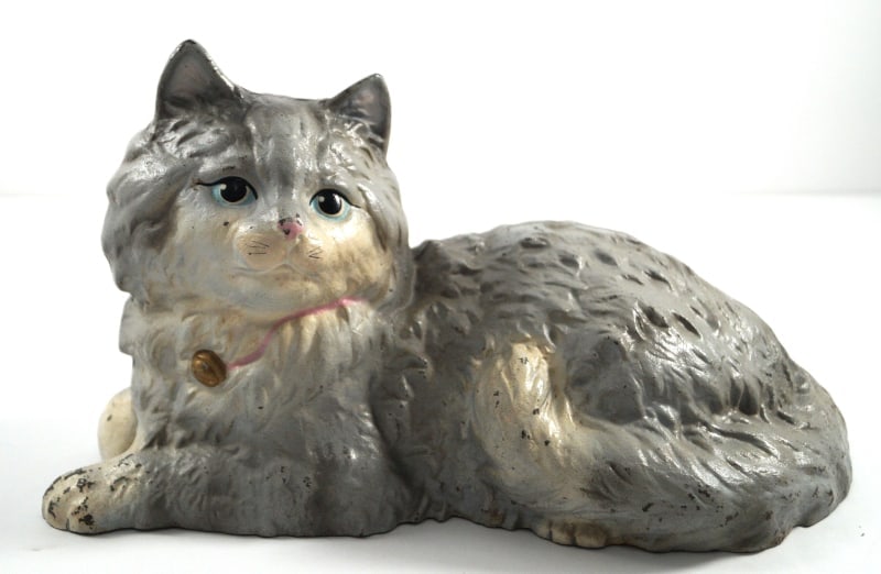 Reclining Cat Cast Iron Hubley Doorstop: Title: Reclining Cat Cast Iron Hubley DoorstopDimension: App. 5 ¾” x app. 10 ¾” longDate: Ca. 1930Additional Information: For all of the cat lovers out there, here is a