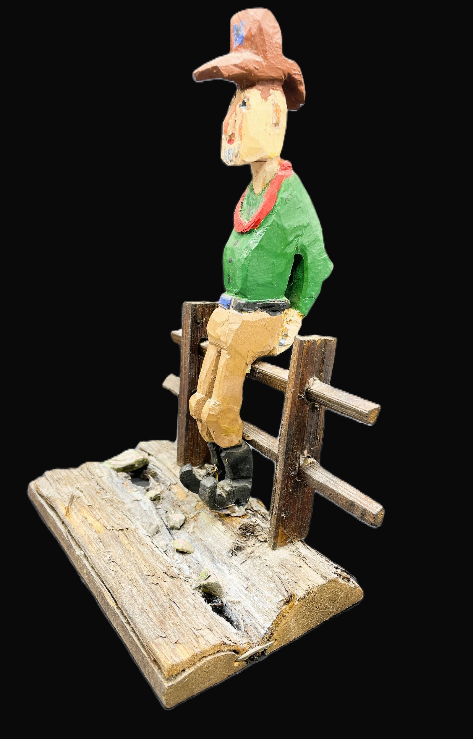 Primitive Folk Art Wooden Cowboy On Fence Hand carved and Painted: Date/Period: UNKNOWNDimension: Approx. 11 x 8.5 x 5Material: woodAdditional Information: Primitive Folk Art Cowboy On Fence. This is a two-piece primitive piece. Provenance Pete Cecere Personal