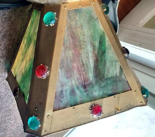 Antique Brass With Stained Jewels Oil Lamp Shade 1880: Great looking piece in good condition. One panel replaced with clear glass and one missing corner but still covers area. Frame is excellent. All jewels are present. Opening on bottom is 3 7/8" to fit