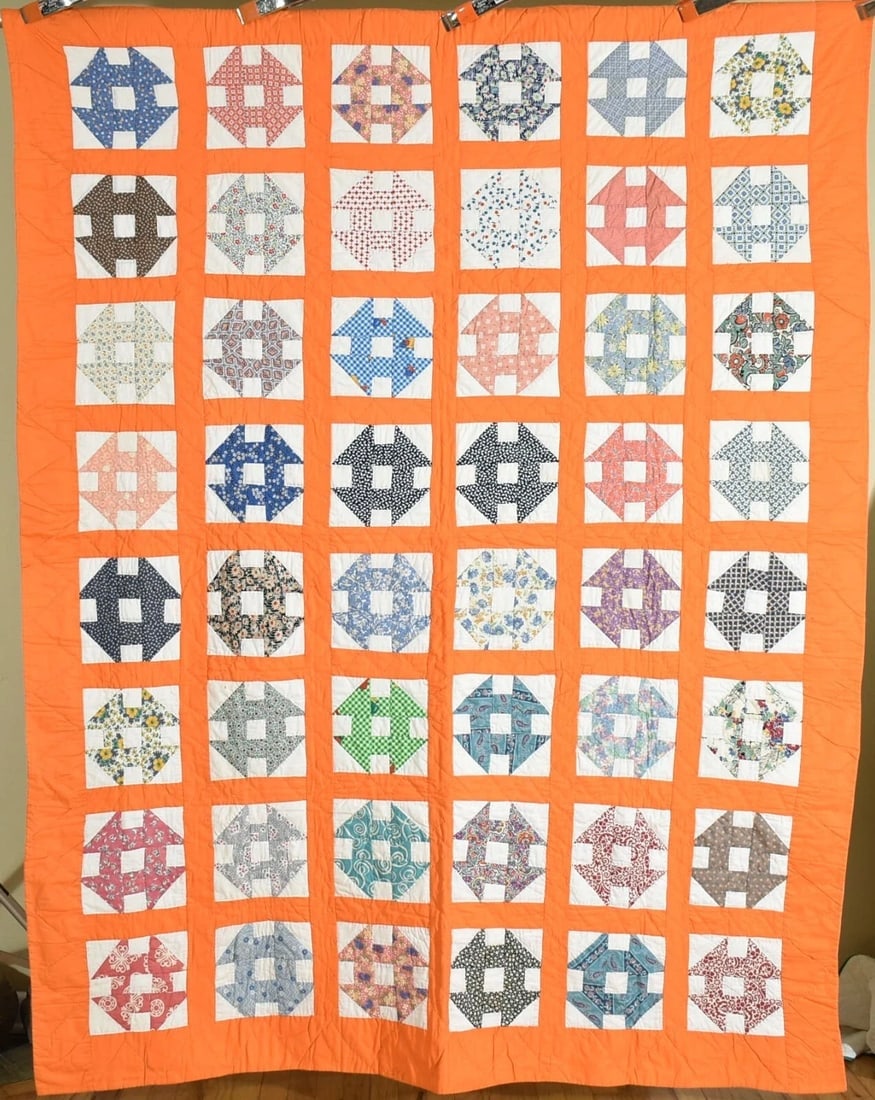 40's Churn Dash Quilt: This wonderful cotton 40's churn dash / "monkey wrench" quilt is all hand pieced and hand quilted, with a vibrant orange background. It measures 68" X 88" and is in excellent, clean condition, with a
