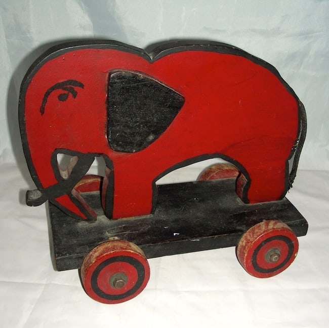 Wooden Elephant Pull Toy w/ Applied Ears & a Scowl: A wonderful wooden elephant pull toy with applied ears and a scowl. Not sure of the exact age, but it most likely dates to the early 1950s, perhaps 1940s; and I don't know if it is a home-made piece