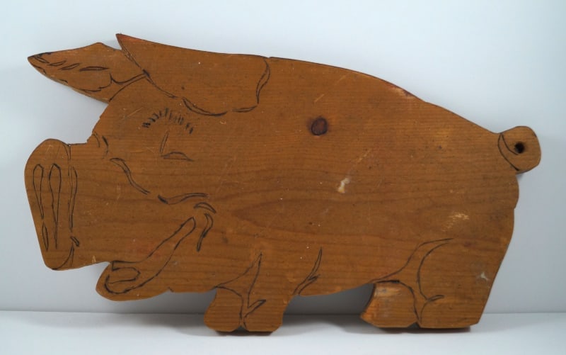 Antique Wooden Pig Cutting Board: Title: Antique Wooden Pig Cutting BoardDimension: 9 3/8” tall x 16” long x ¾” thickDate: Ca. 1940’s.Additional Information: Antique wooden Pig Cutting Board with
