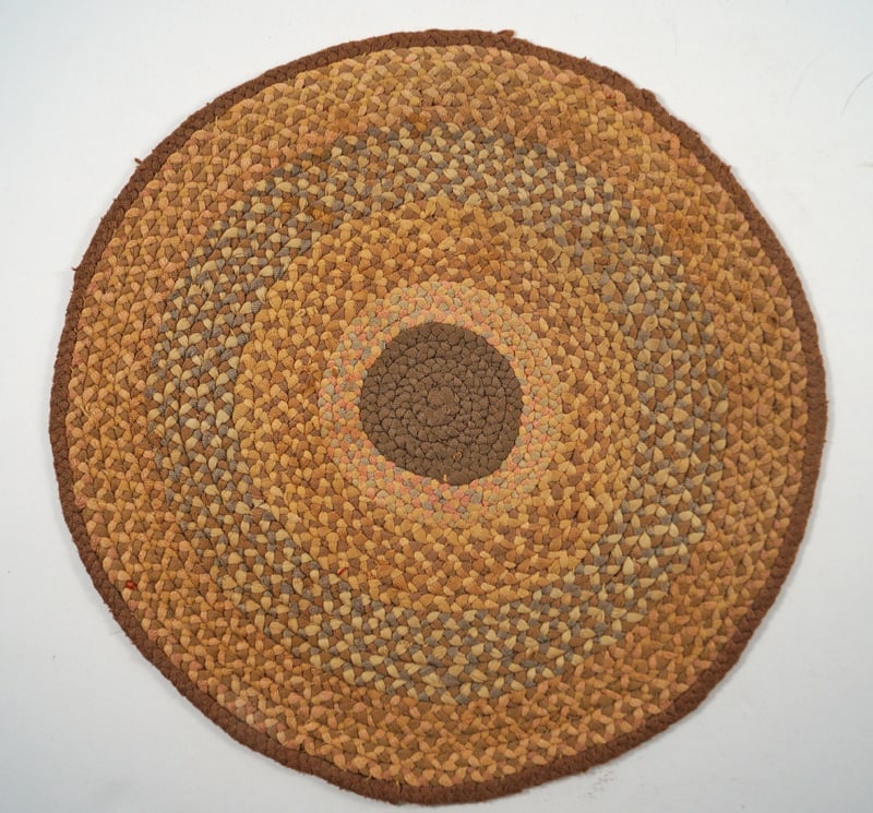 Antique Braided Table Mat Country Americana #5: Title: Antique Braided Table Mat Country Americana #5Dimension: App. 9 1/2” diameterDate: Ca. 1930’s-40’sAdditional Information: An intricate Antique Braided Table Mat. Round in