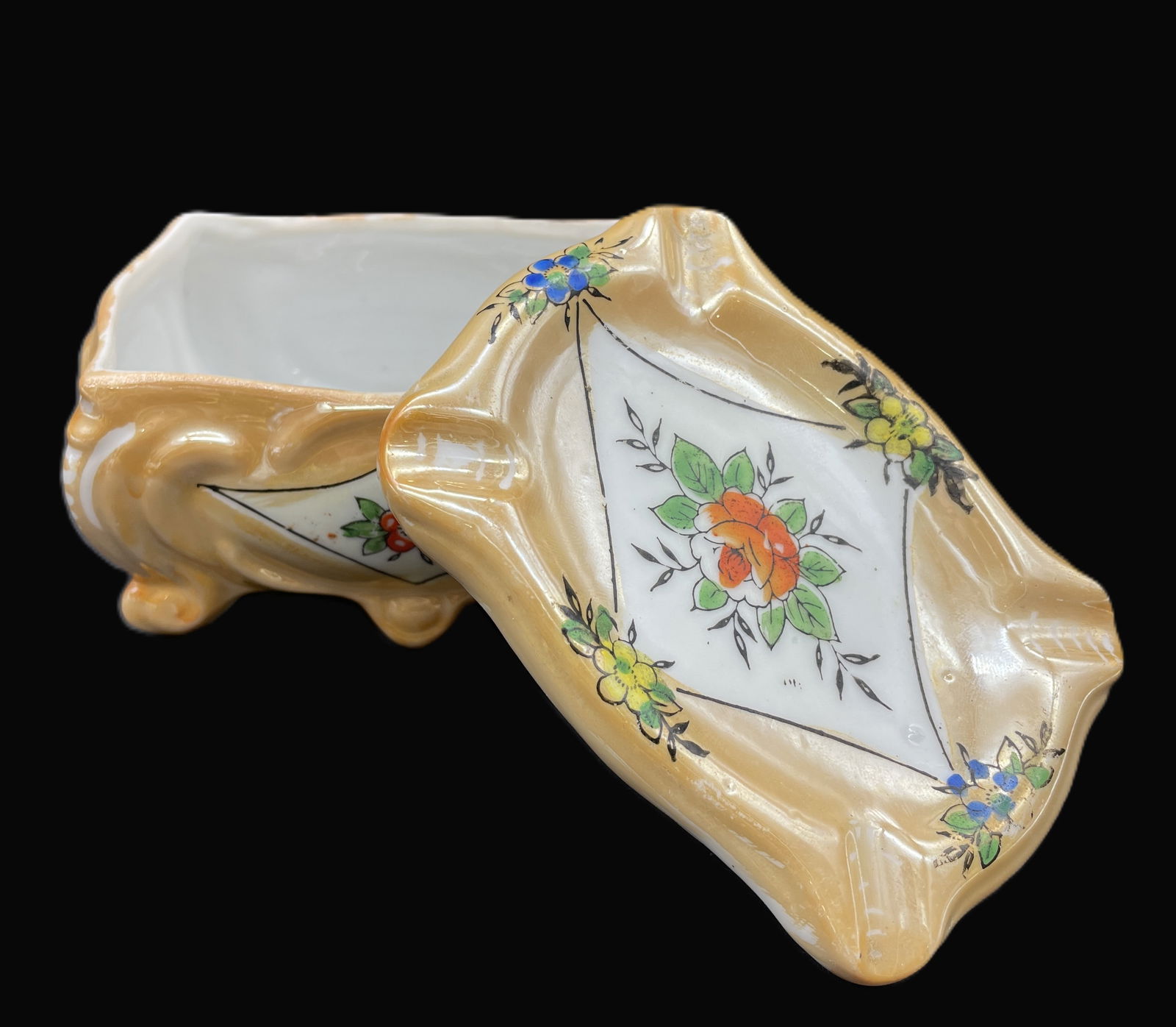 Vintage Porcelain Cigarette Trinket Box Made In Japan Floral: Date/Period: approx 1950'sDimension: approx 2" tall x 4" x 3"Material: ceramic porcalinAdditional Information: Delve into the elegance of a bygone era with this Vintage Porcelain Cigarette Trinket