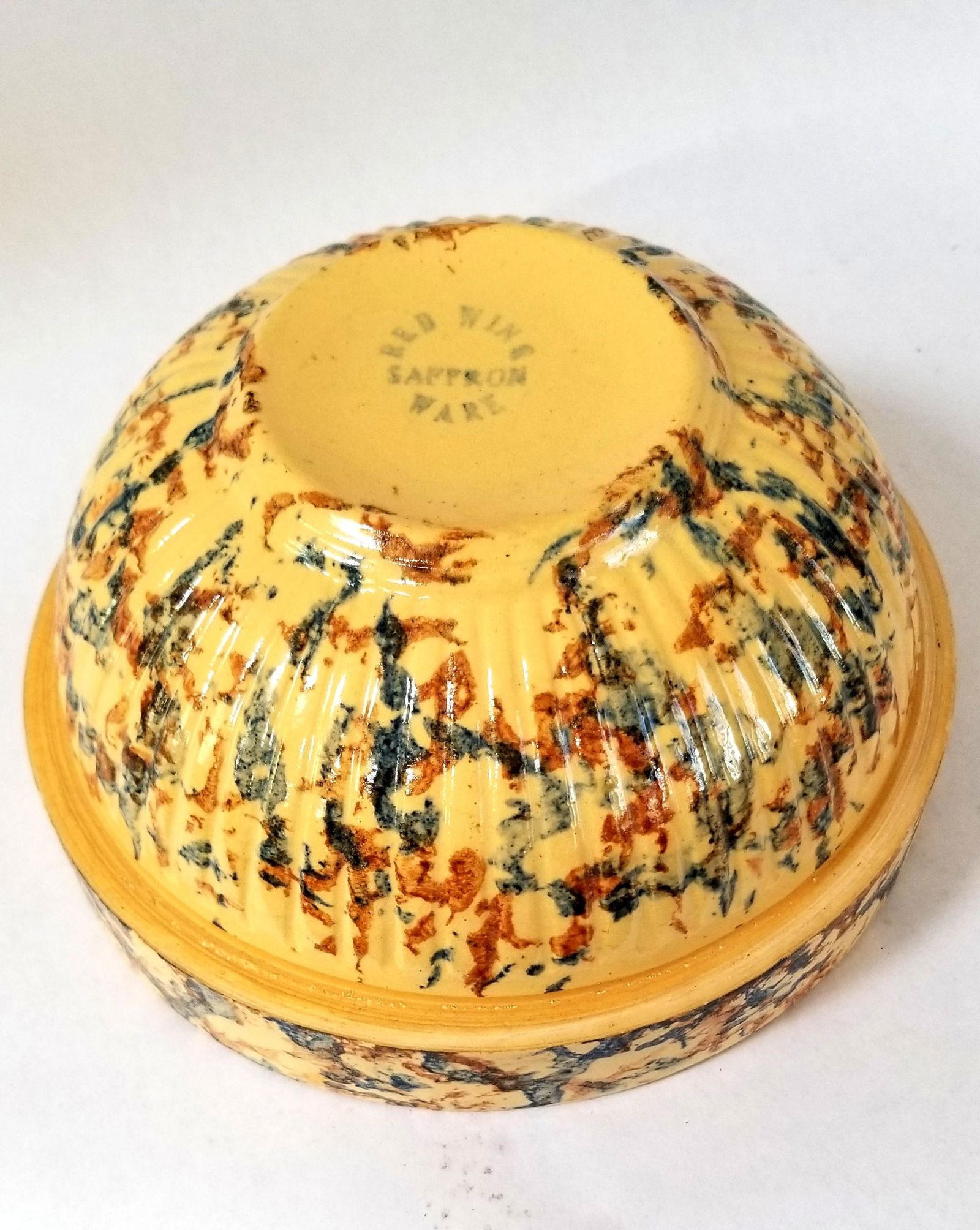 Yellowware bowl from the famous Red Wing Pottery, Red Wing Minnesota: Two-color sponging. Advertising says 1937 for Lampert Yards. Red Wing called this Saffron Ware..saffron is a yellow spice. 7 3/4" diameter. Shipping:Domestic: Shipping rates are