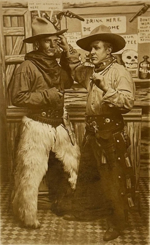 RPPC Real Photo Postcard Studio Cowboys 'Drink Here Die Home' Fun Card 1900: Real photo postcard of two men dressed as cowboys complete with chaps and hand guns. Sign over the bar - 'Drink Here Die Home'. Card in very good condition - please see images. Postally unused. Circa