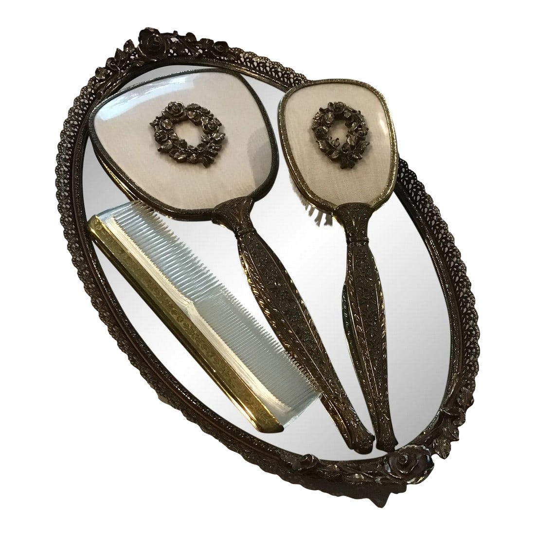 Vintage 1950's Hollywood Regency Gold Tone Rose Vanity Set - 4 Piece Set Oval Mirror Vanity Tray,: Vintage 1950's 4 pc Ormolu Vanity Set Gold tone filigree mirror tray with rose motif Hand held mirror and brush with wreath of roses Both have ivory color moire fabric backing Clear comfy with gold