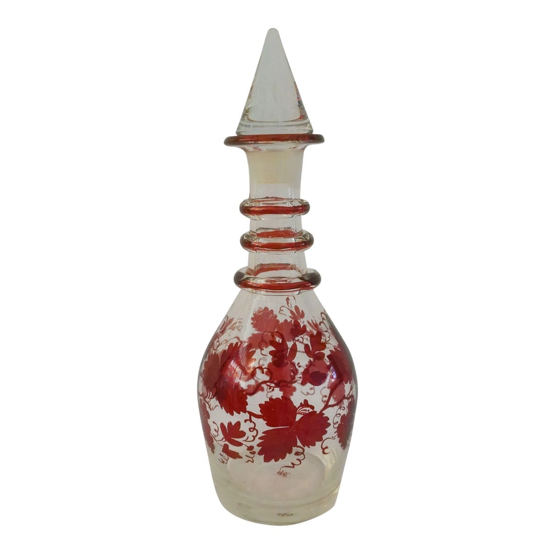 Mid-Century Crystal Grapevine Aperitif Decanter: Lovely mid-century crystal Aperitif/cordial liquor decanter featuring a burgundy grapevine motif around perimeter with a cone shaped glass stopper. No maker's mark. Condition: Alterations: Original