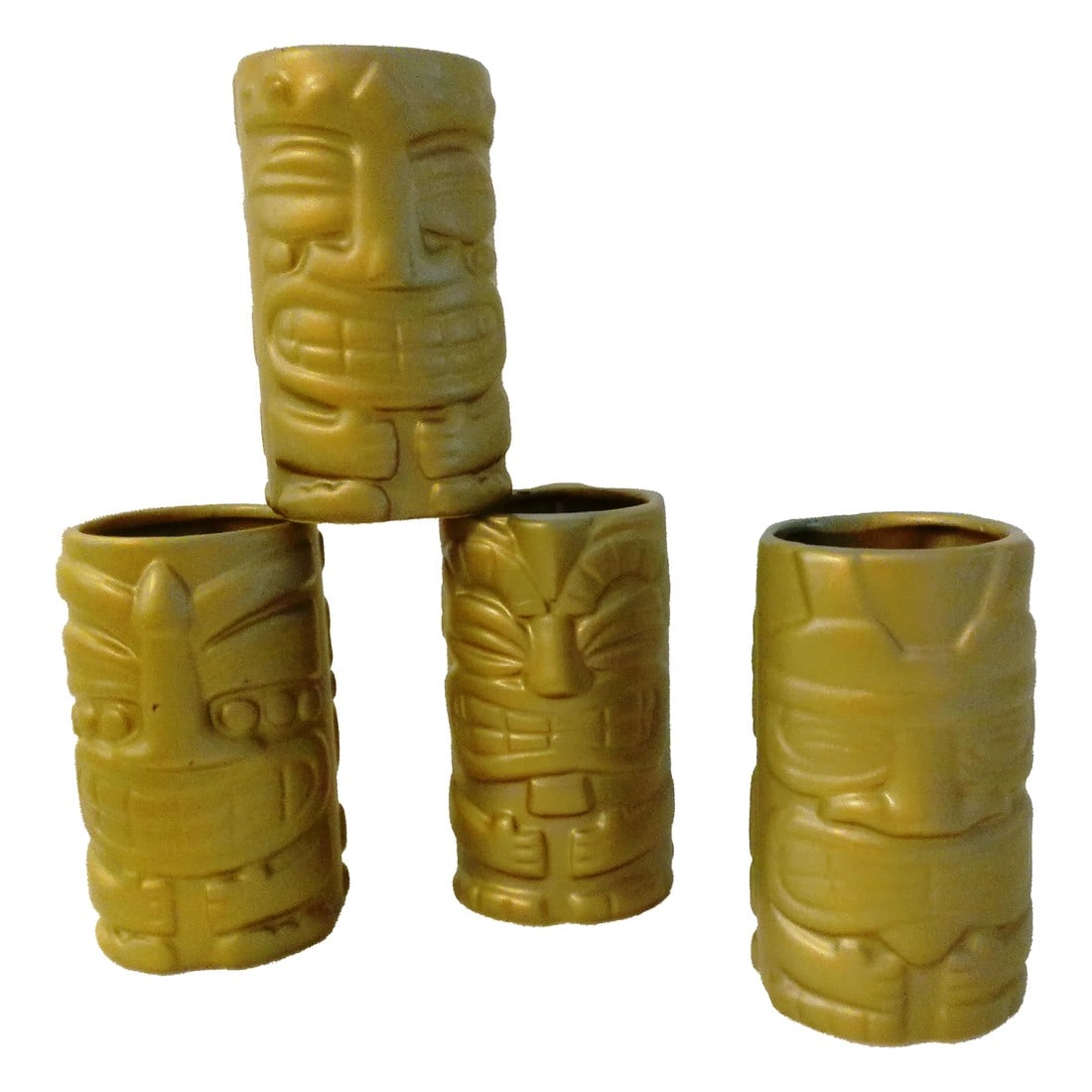1970s Matte Gold Tiki Highball Tumblers, Set of 4: Stylish set of four vintage ceramic Tiki tumblers in a matte gold finish, each with a different face. Each tumbler holds 12 ounces. Hand wash. Condition: Alterations: Original Condition Unaltered