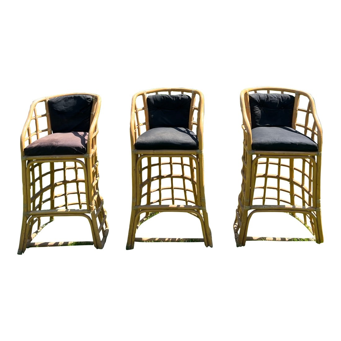 1970's Bamboo Bar Stools - Set of 3: These three retro barstools can bring great tiki bar vibes with their unique modernist design in the style of Paul Franko. The base is sturdy and the back and arms provide relaxing support for fun