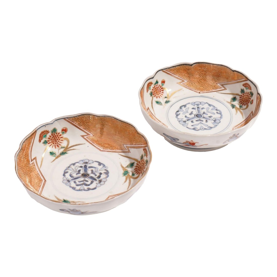 Pair of Japanese Imari Porcelain Footed Bowls, C. 1800's: Pair of Japanese porcelain footed bowls in red, green, and blue, highlighted with gold decoration. The decoration centers on a cobalt under glaze central medallion the Imari taste. On the under foot a