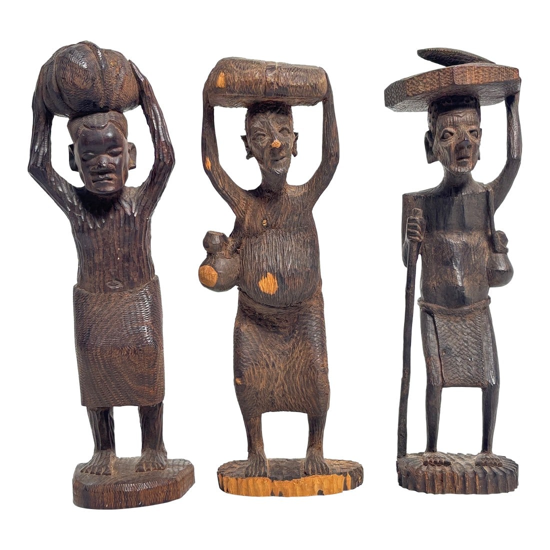 Set of Three 1970s East African Wood Carved Figure Statues, Sculptures: Obtained from East Africa in the 1970s. Each statue is hand-carved from solid hardwood and shows individual expression and pose "” gracefully elongated forms, worn patina, and tool marks that