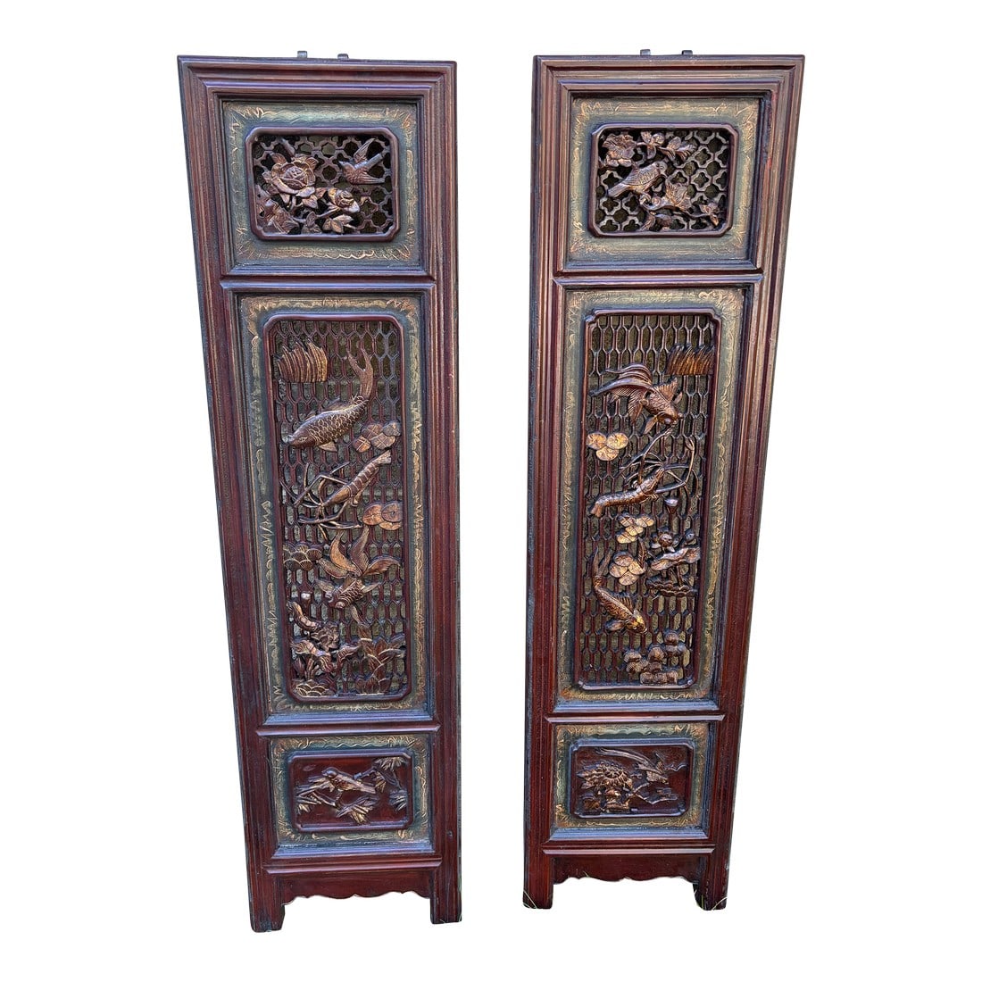1875 Chinese Red Intricate Wooden Carved Door Panels in Gold, a Pair: Each panel showcases deeply carved florals, mythical motifs, or symbolic patterns that speak to prosperity and protection, all preserved in a rich red lacquer that has mellowed beautifully with age.