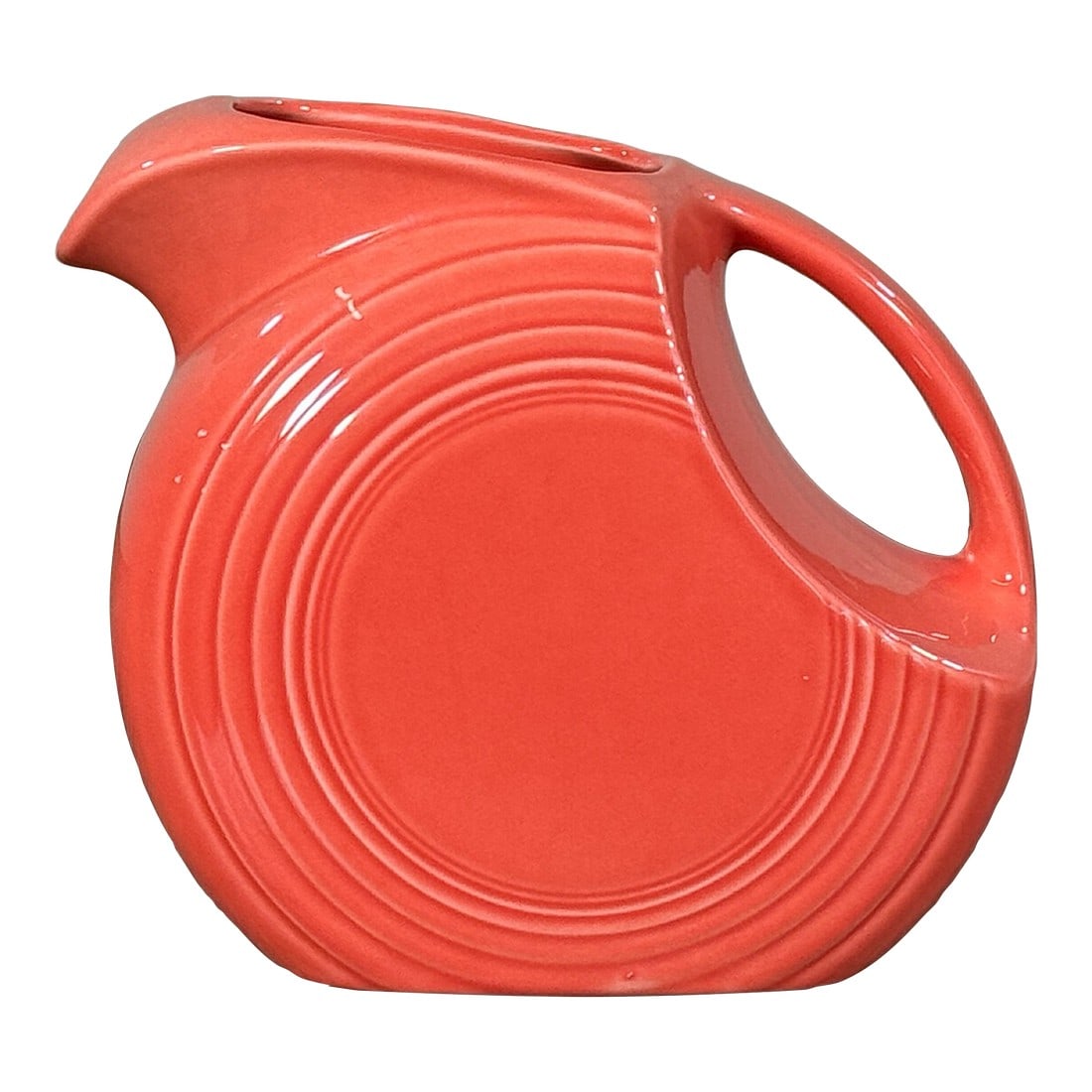 Vintage Fiesta Ware Disc Pitcher in Red Persimmon Glaze by Homer Laughlin: Vintage Fiesta Ware ceramic disc pitcher by Homer Laughlin, produced in the United States and marked on the underside. Features the classic concentric ring form with integrated handle and spout,