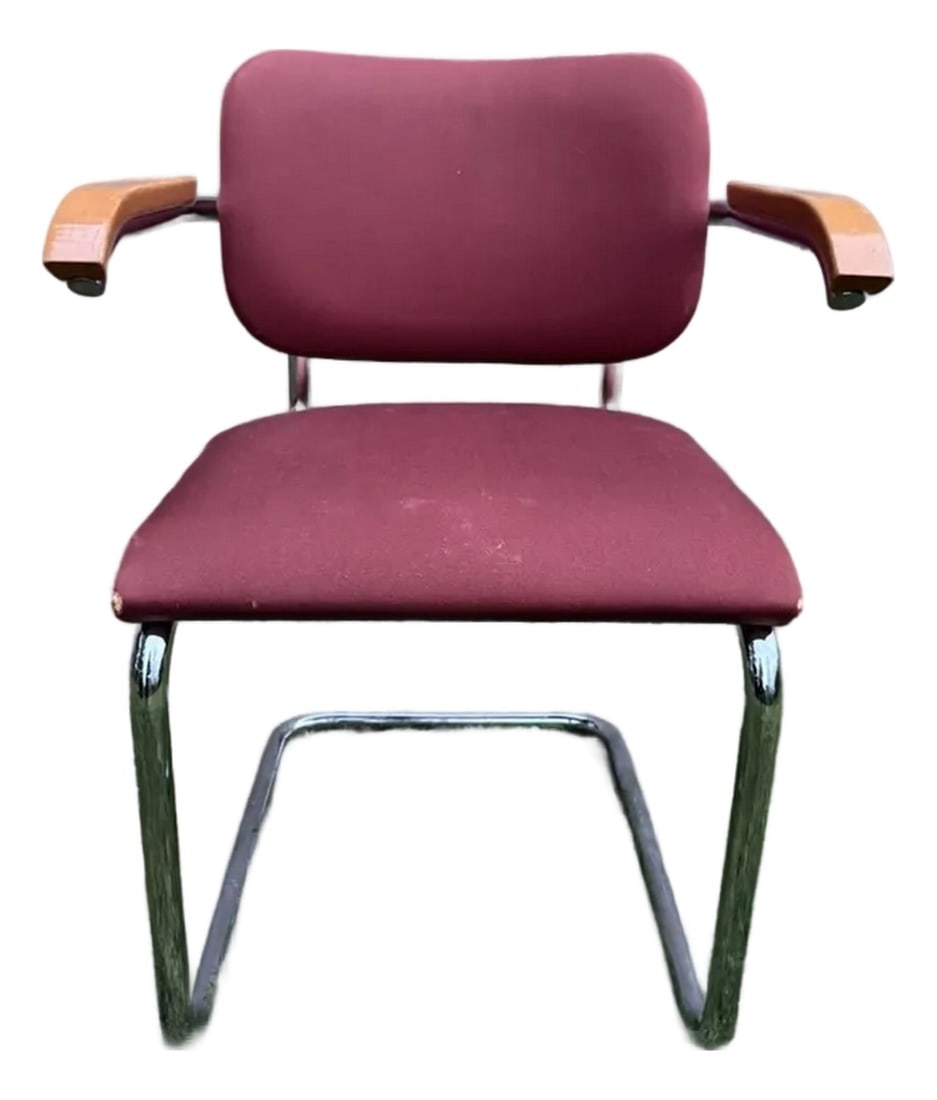 Vintage Cesca-Style Upholstered Armchair: Vintage Cesca-Style Upholstered Armchair A classic Cesca-style armchair featuring a vibrant orange upholstered seat and back, complemented by solid light wood armrests and sleek chrome cantilever fram