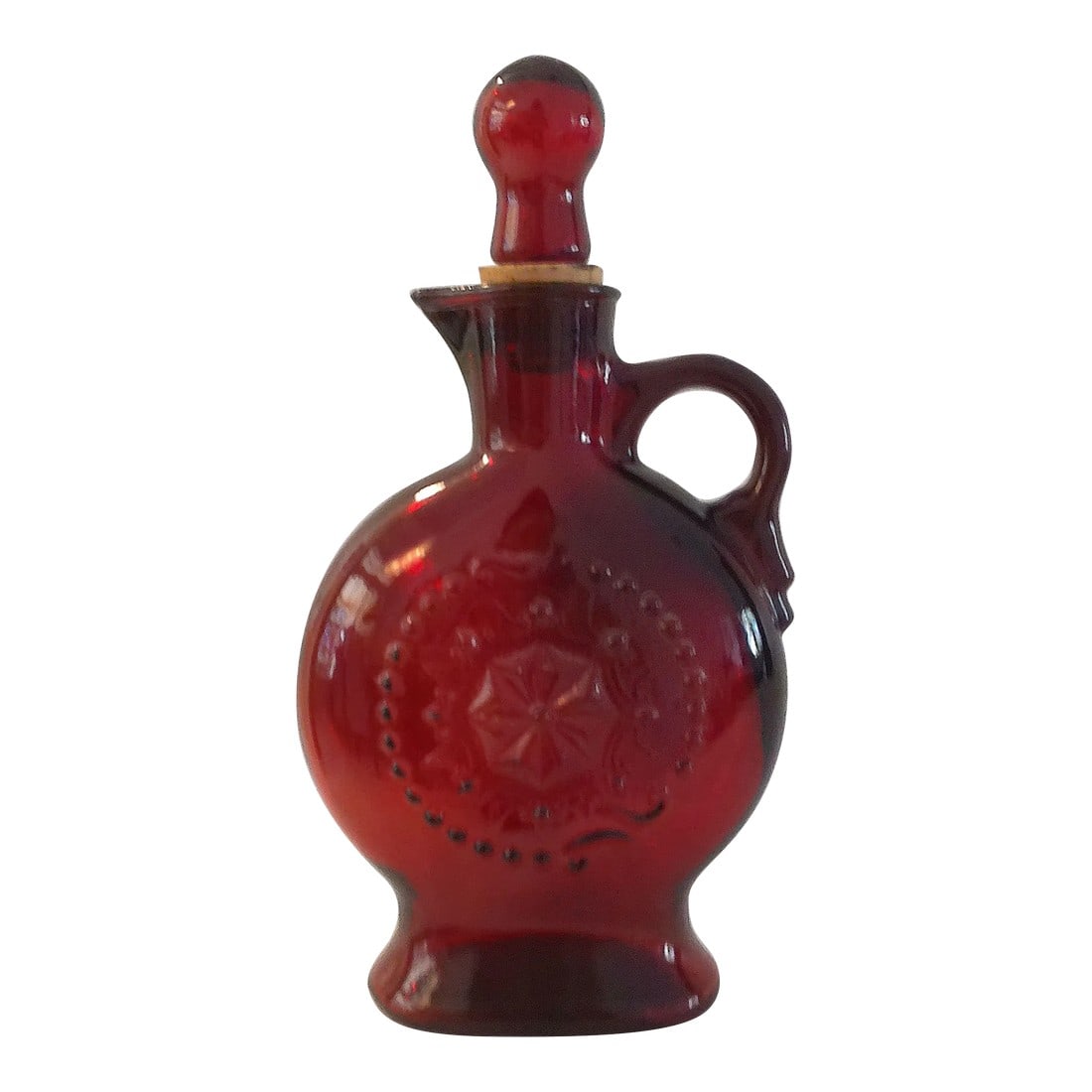 Vintage Ruby Red Americana Glass Decanter: Vintage ruby red handled glass decanter featuring a decorative raised motif on face and glass cork lined stopper. No maker's mark. Condition: Alterations: Original Condition Unaltered