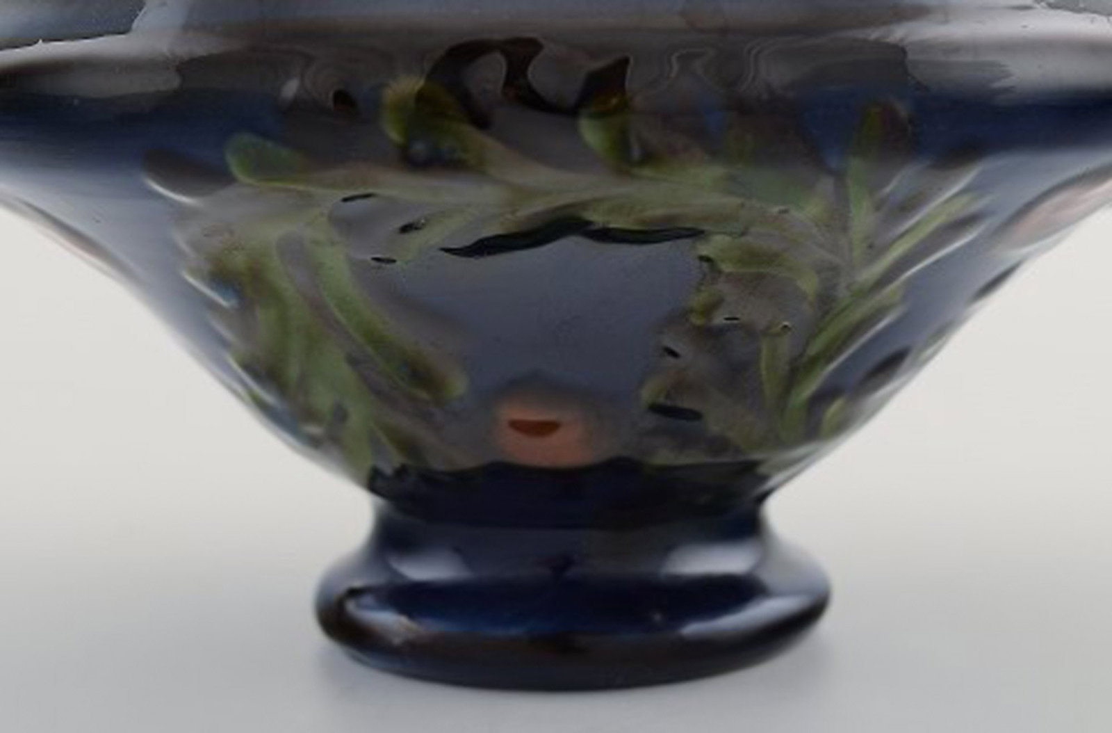 Kähler, Denmark. Bowl in glazed ceramics. Green leaves and red berries on a dark blue - 5