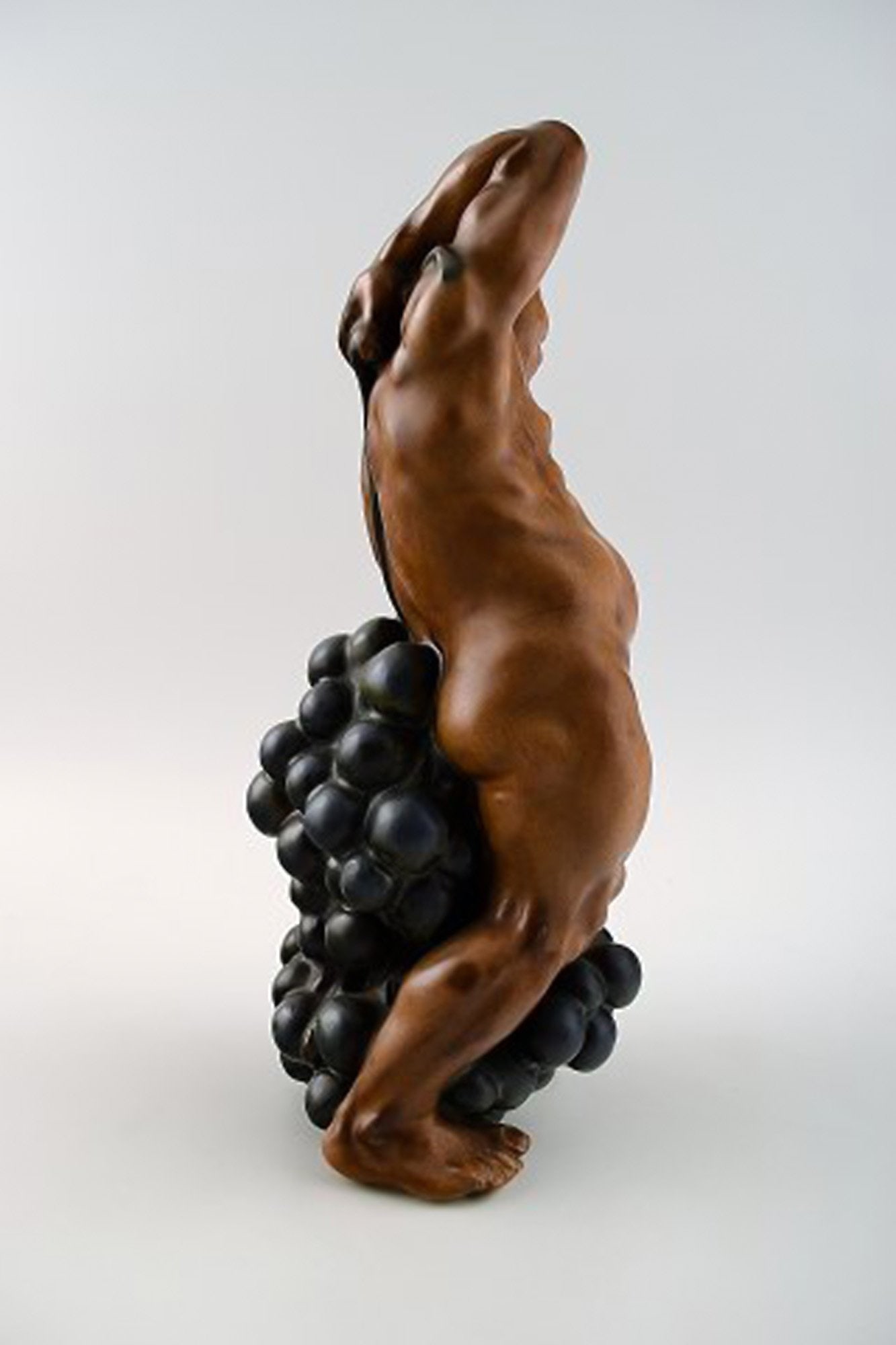 Bing & Grondahl Figurine of a man standing with grapes by Kai Nielsen. Model number 4025. From the - 2