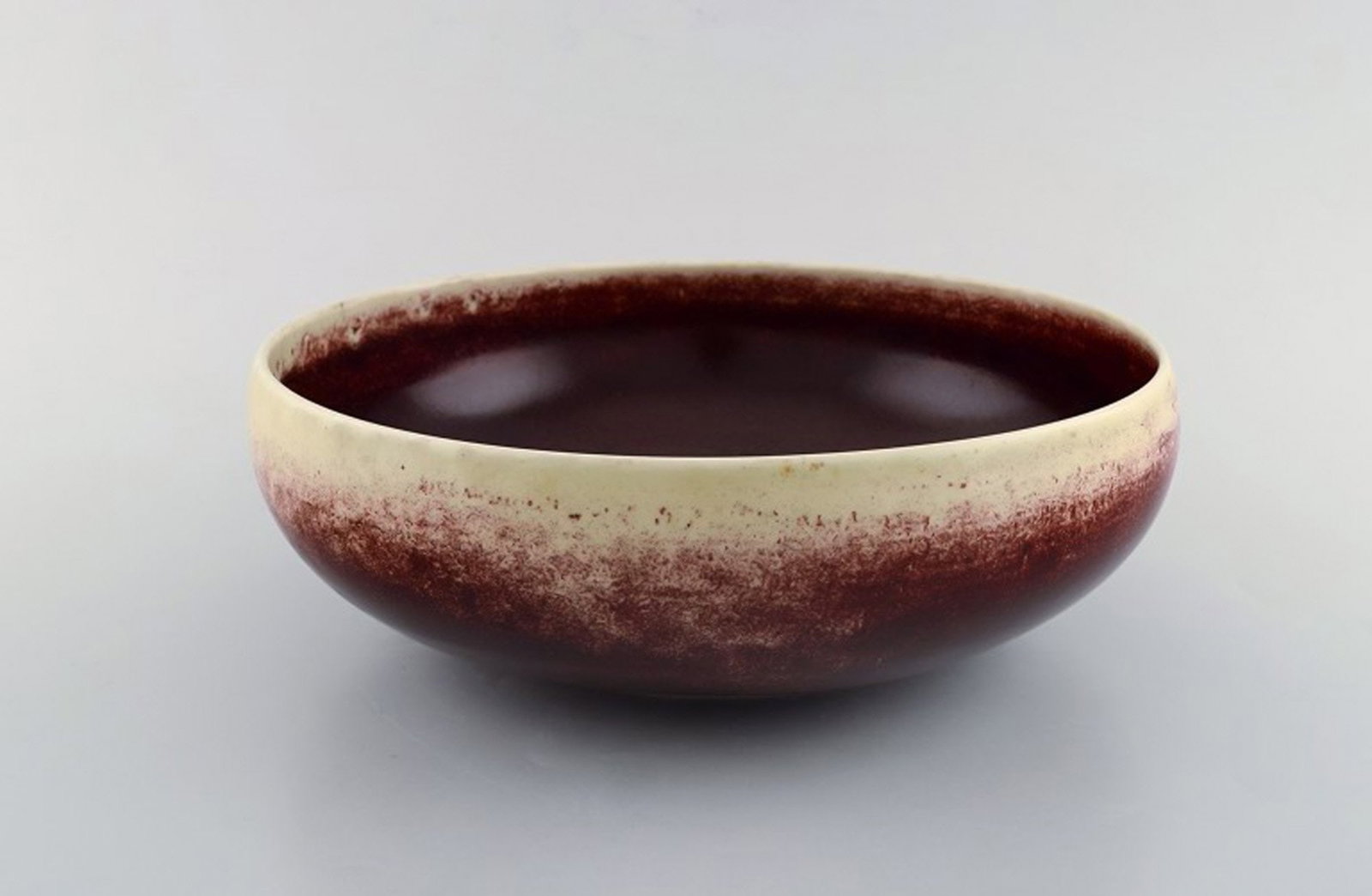 Sven Wejsfelt for Gustavsberg Studio Hand. Unique bowl in glazed ceramics. Dated 1988. Beautiful ox: Title: Sven Wejsfelt for Gustavsberg Studio Hand. Unique bowl in glazed ceramics. Dated 1988. Beautiful ox blood glaze on cream colored background. Description: Sven Wejsfelt for Gustavsberg Studio Ha