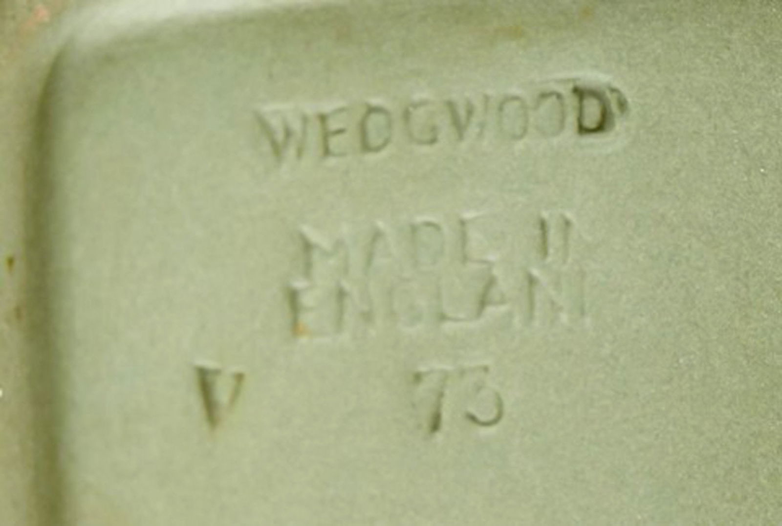 Wedgwood, England. Small square dish in green stoneware with classicist scenes in white. Approx. - 4