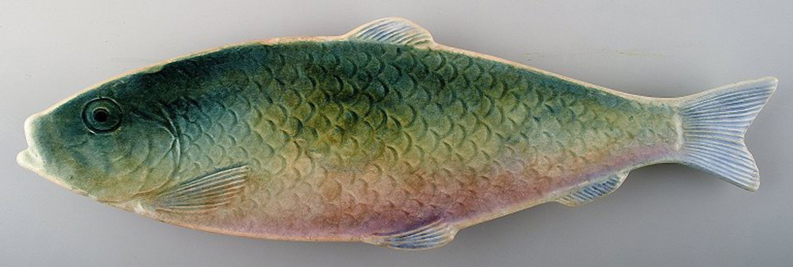 Gustavsberg fish shaped earthenware dish.: Title: Gustavsberg fish shaped earthenware dish. Description: Gustavsberg fish shaped earthenware dish. Beautiful multi-colored glaze. Stamped: Gustavsberg, approximately 1900. Length: 32.5 cm. In per