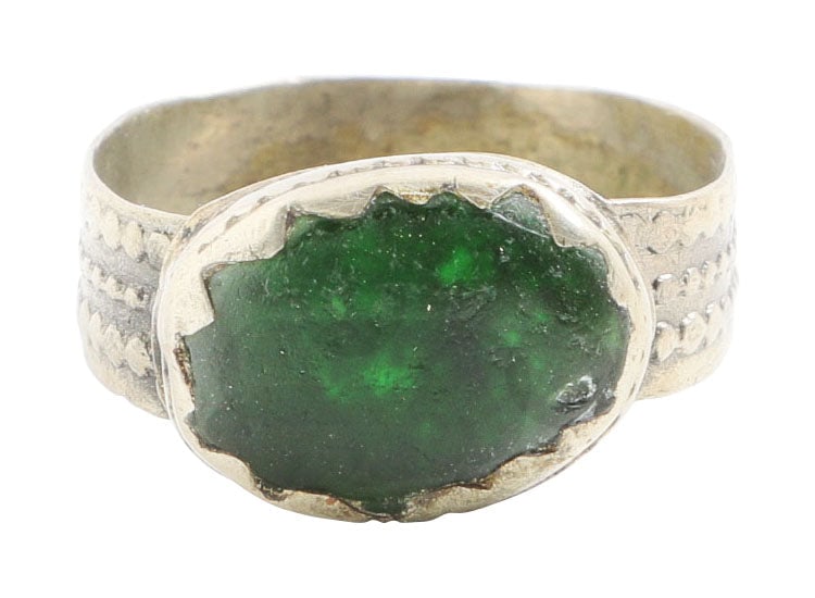EASTERN EUROPEAN GYPSY RING, SIZE 10 1/4: White metal/base silver. Broad band, 5mm, flaring to the pelleted decorated shoulders. Large oval bezel with pelleted medial. Rounded face green "stone" in tall bezel mount. Charming provincial manufa