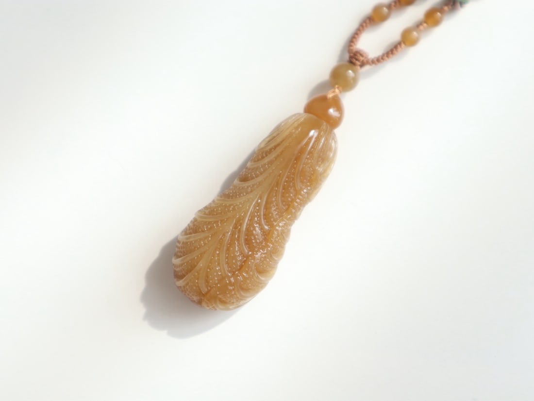 Hetian Jade Hand-Carved Cabbage Pendant: Title: Hetian Jade Hand-Carved Cabbage Pendant Origin: Chinese Date/Period: After2025 Materials: Hetian Jade Dimensions: 47.2x19x13.6(mm) 1.860.75x0.54(inches) Reserve: $259.00 