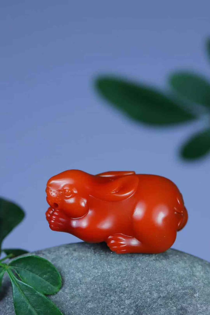 Nanhong Agate Hand-Carved Rabbit Pendant with Certificate: Title: Nanhong Agate Hand-Carved Rabbit Pendant with Certificate Origin: Chinese Date/Period: After2026 Materials: Nanhong Agate Dimensions: 29x16.6x13.4(mm) 1.14x0.65x0.53(inches) Weight 0.02 lbs/8.5