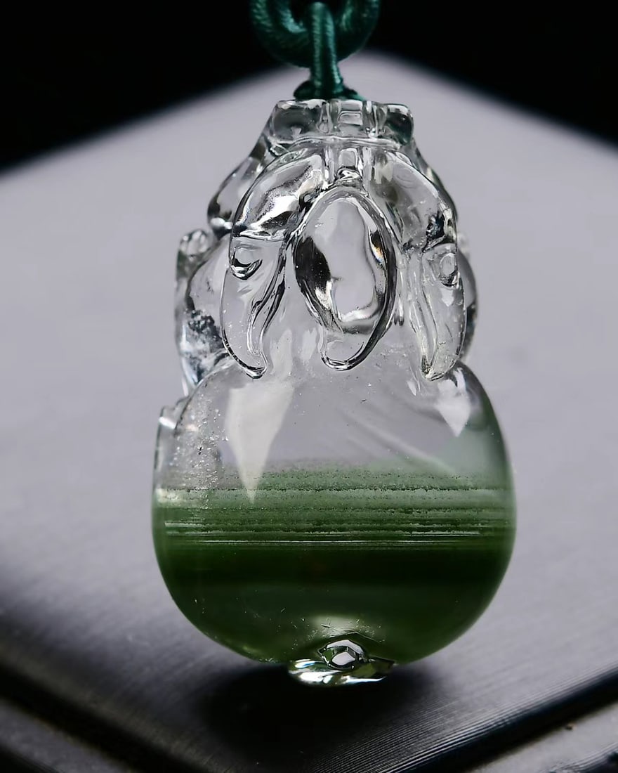 Natural Green Crystal Pendant - Pixiu: Title: Natural Green Crystal Pendant - Pixiu Origin: Chinese Date/Period: After2026 Materials: Crystal Dimensions: 37x23x15(mm) 1.46x0.91x0.59(inches) Weight 0.05 lbs/23.3g Reserve: $238.00 Shipping:<