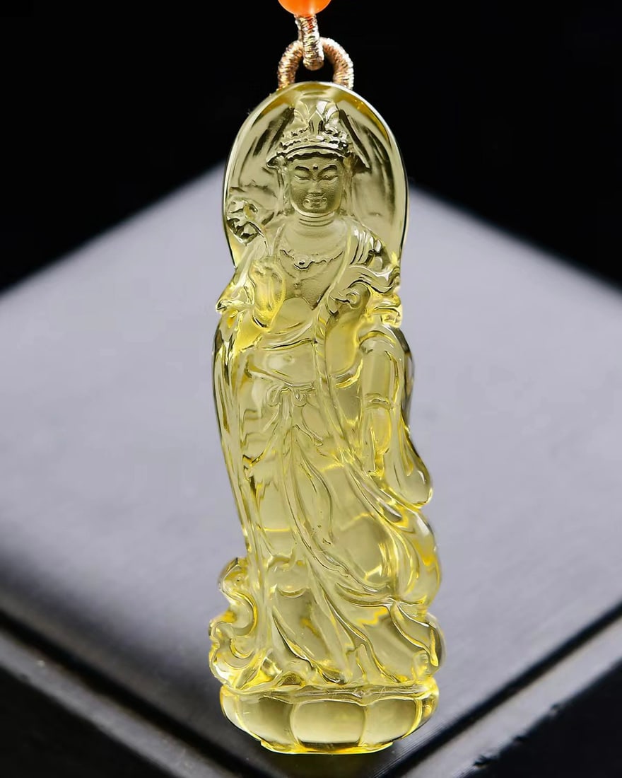 Yellow Crystal Hand-Carved Kwan-yin Pendant with Certificate: Title: Yellow Crystal Hand-Carved Kwan-yin Pendant with Certificate Origin: Chinese Date/Period: After2025 Materials: Crystal Dimensions: 67x23x10(mm) 2.64x0.91x0.39(inches) Weight 0.07 lbs/31.8g Rese