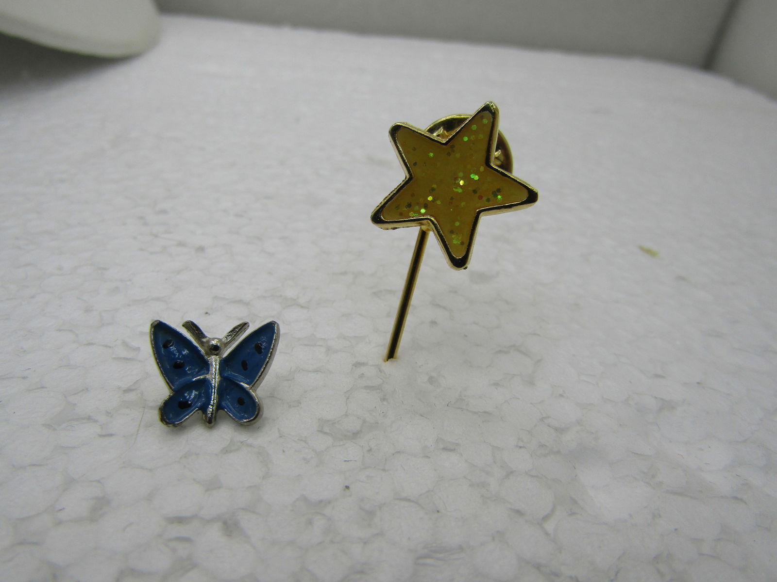 Vintage Enameled Butterfly & Star Tack Pin Lot, 2 Pins, Blue/Yellow: Vintage Enameled Butterfly & Star Tack Pin Lot, 2 Pins, Blue/Yellow, The butterfly is blue, silver tone and appx. 1/2", the star is a stick pin, yellow glittered enameling and 1.75" long and 3/4" wide