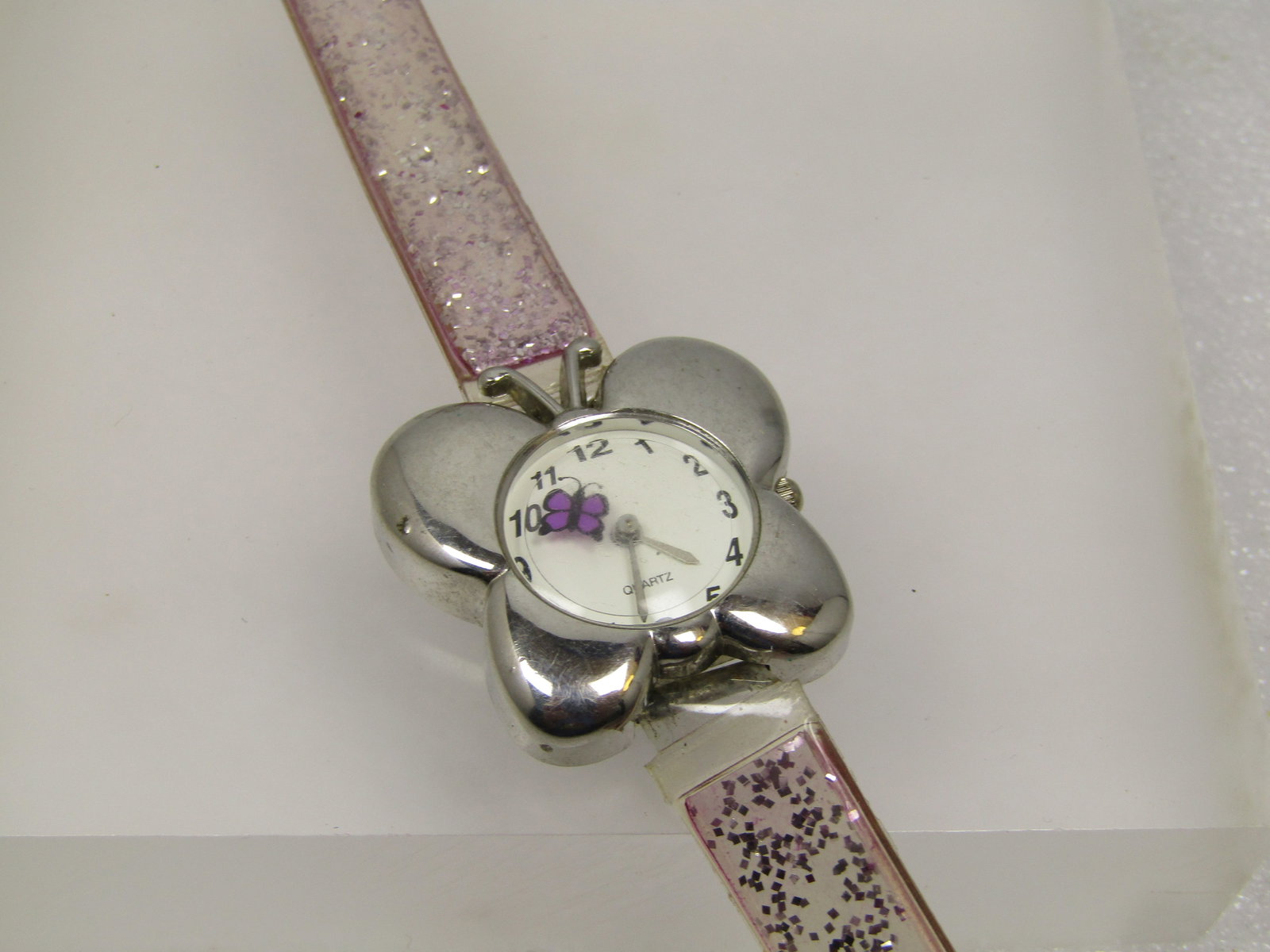 Extreme Limit Butterfly Watch with Pink Glitter Band, 1980's-1990's: Extreme Limit Butterfly Watch with Pink Glitter Band, 1980's-1990's. The back is marked A23-01 47711K and marked EXTREMElimit Japan Movement . It runs - a new batterly has been added - the stem is