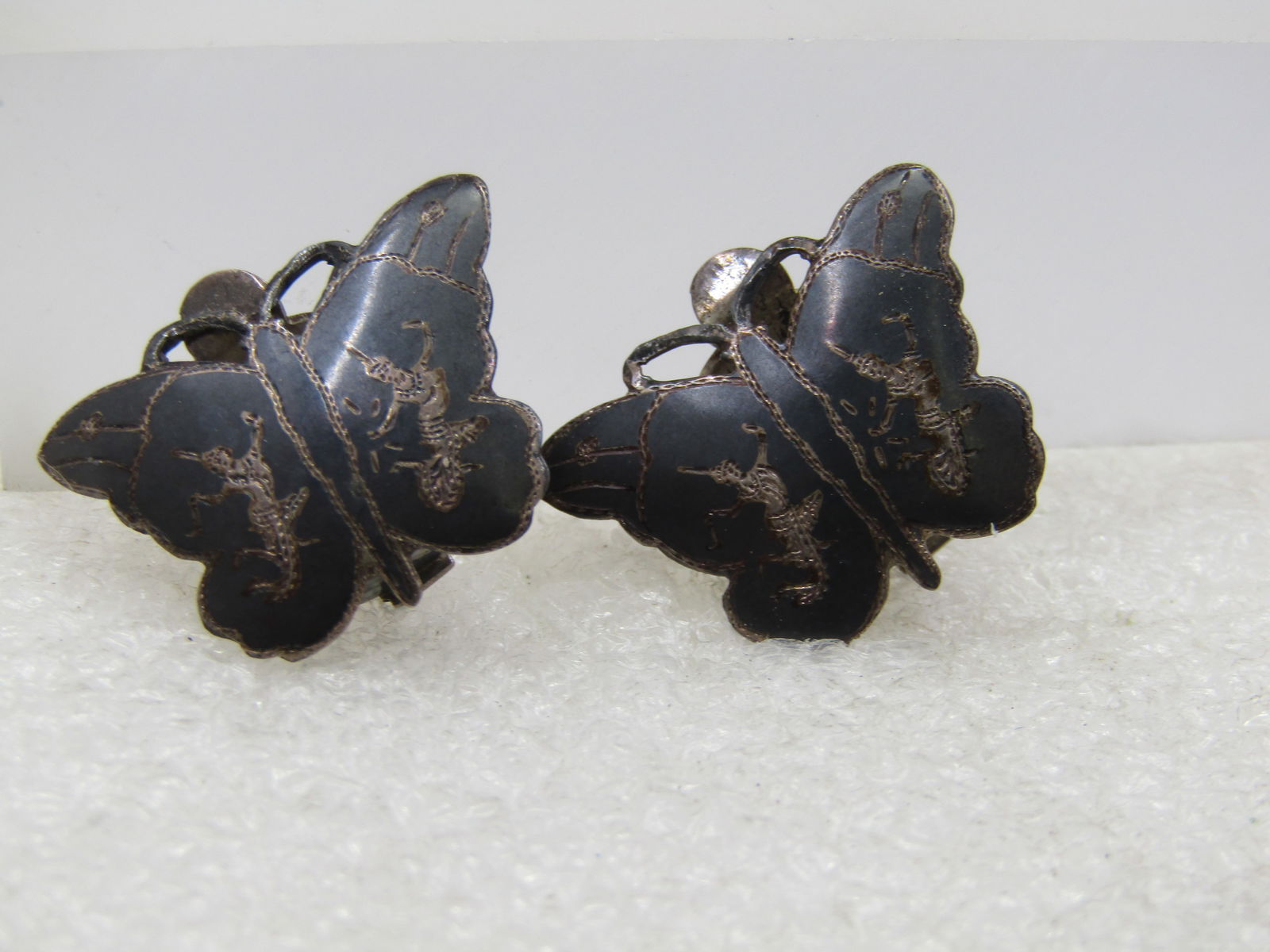 Vintage Siam Goddess Butterfly Earrings, Clip, 1930's-1950's: Vintage Siam Goddess Butterfly Earrings, Clip, 1930's-1950's. Black enameled with two goddesses engraved on each earring with butterfly details also engraved. The earrings are appx. 3/4" tall and 1" w