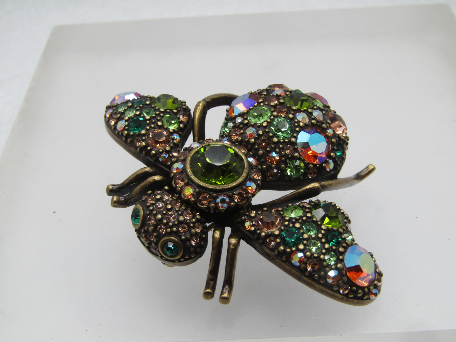 Vintage Large Rhinestone Bee Brooch, Joan Rivers, 1990's: Vintage Large Rhinestone Bee Brooch, Joan Rivers, 1990's. Gold tone. Dark gold tone brooch with a mix of green, amber shades of rhinestones, some with aurora borealis finish and a mix of sizes too. Th