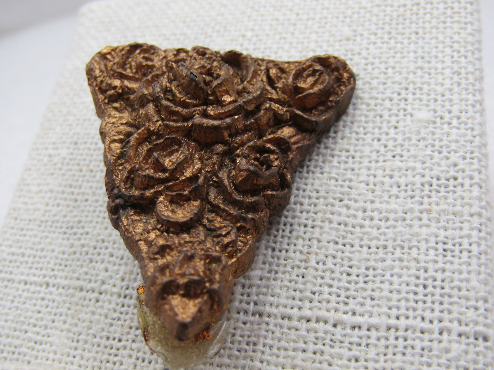 Vintage Gold Painted Rose Triangular Brooch, Plastic, 1910-1920's: Vintage Gold Painted Rose Triangular Brooch, Plastic, 1910-1920's. Molded plastic rose brooch that is 1.5" tall and 125_ wide at top. The very tip is raised away from the plastic c-clasp in back. Good