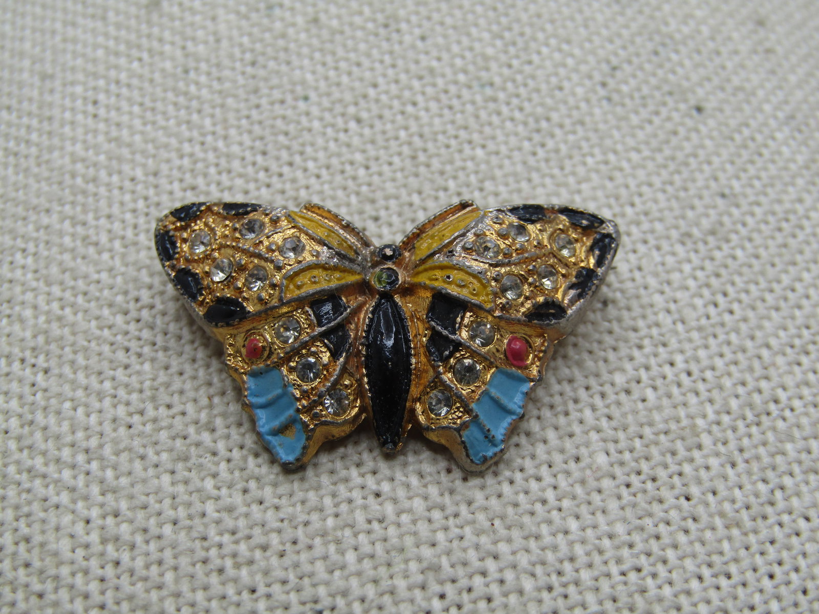 Vintage Enameled Rhinestone Butterly Perfume Brooch, 1920's-1930's, C-Clasp: Vintage Enameled Rhinestone Butterly Perfume Brooch, 1920's-1930's, C-Clasp. this butterfly has domed wings with rhinestones and enameling throughout. Gold tone. C-Clasp. On the back here are circulul
