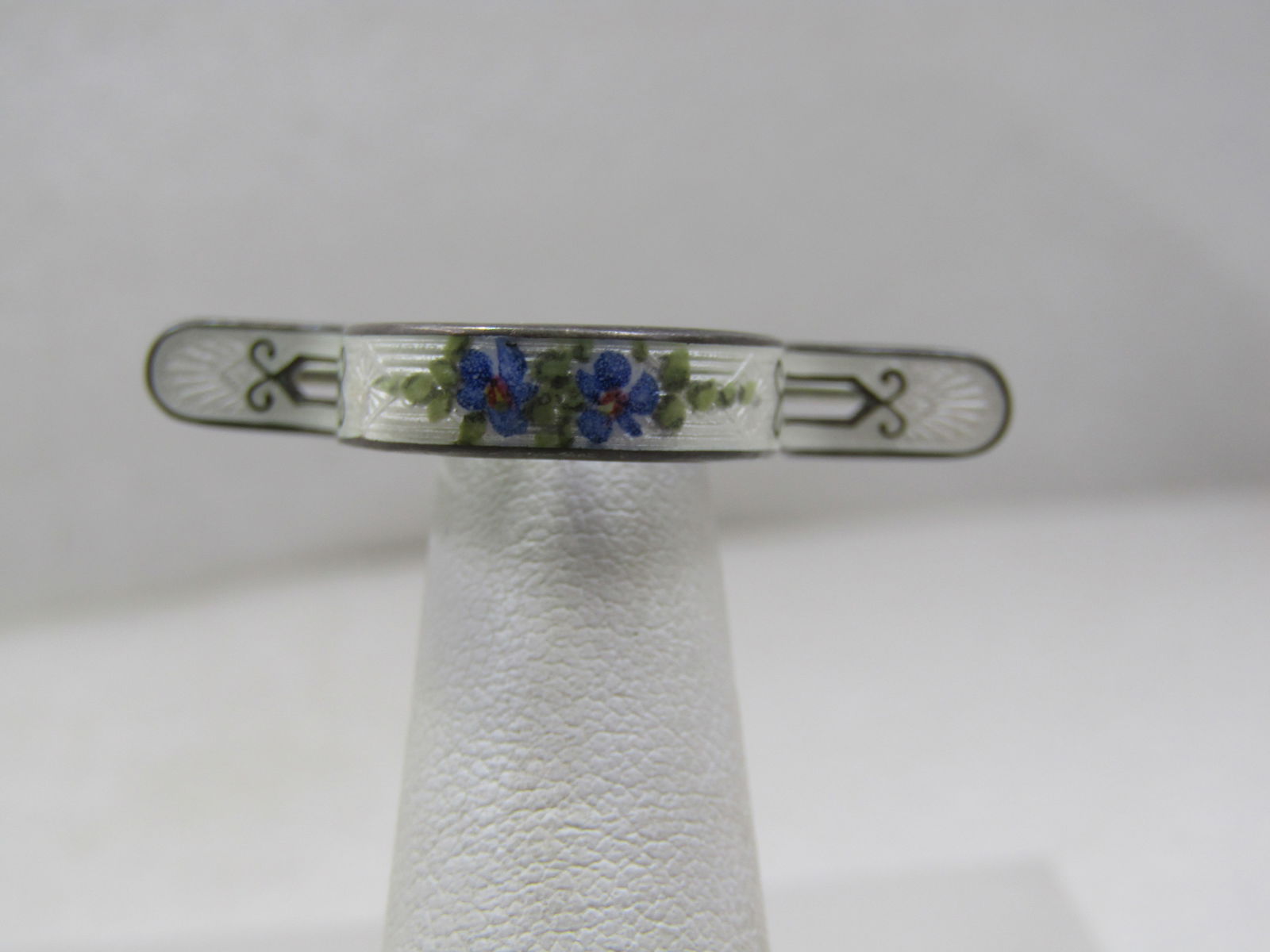 Victorian Sterling Guilloche Curved Floral Holder Brooch/Tussie Mussie: Victorian Sterling Guilloche Curved Floral Holder Brooch/ This is a Victorian era Tussie Mussie or Posy Holder with guilloche enamel floral design with white background and blues and greens. It is