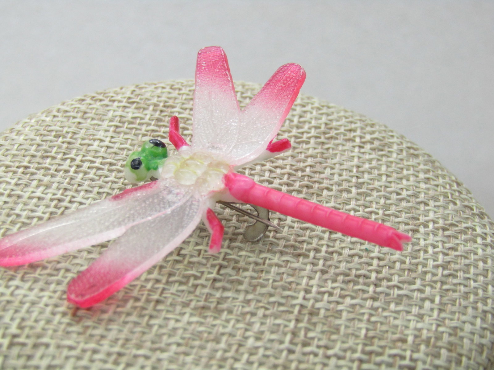 Vintage Pink Dragonfly Brooch, 1.5" Long, 17.5" wide, Plastic: Vintage Pink Dragonfly Brooch, 1.5" Long, 17.5" wide, Plastic, 1950's-1960's. Translucent plastic with pink painting on legs, tail, wing tips and green head with black eyes. C-Clasp. The leg on one si