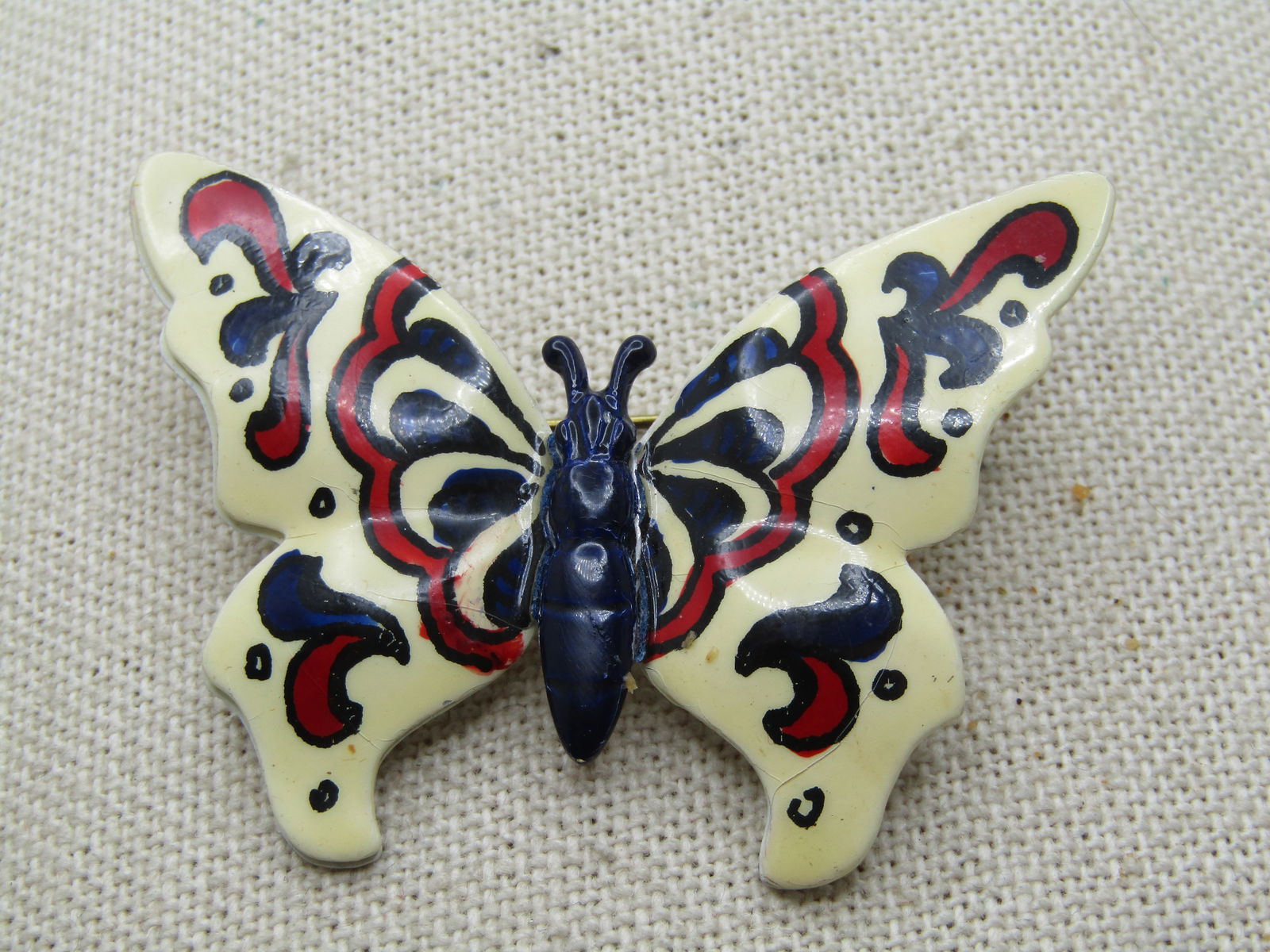 Vintage Enameled Red/White/Blue Butterfly Brooch, Germany, 1950's-1960's: Vintage Enameled Red/White/Blue Butterfly Brooch, Germany, 1950's-1960's. The wings are slightly domed with blue enameled torso and antenna. It has enameled red and blue designs on the wings. It is ap