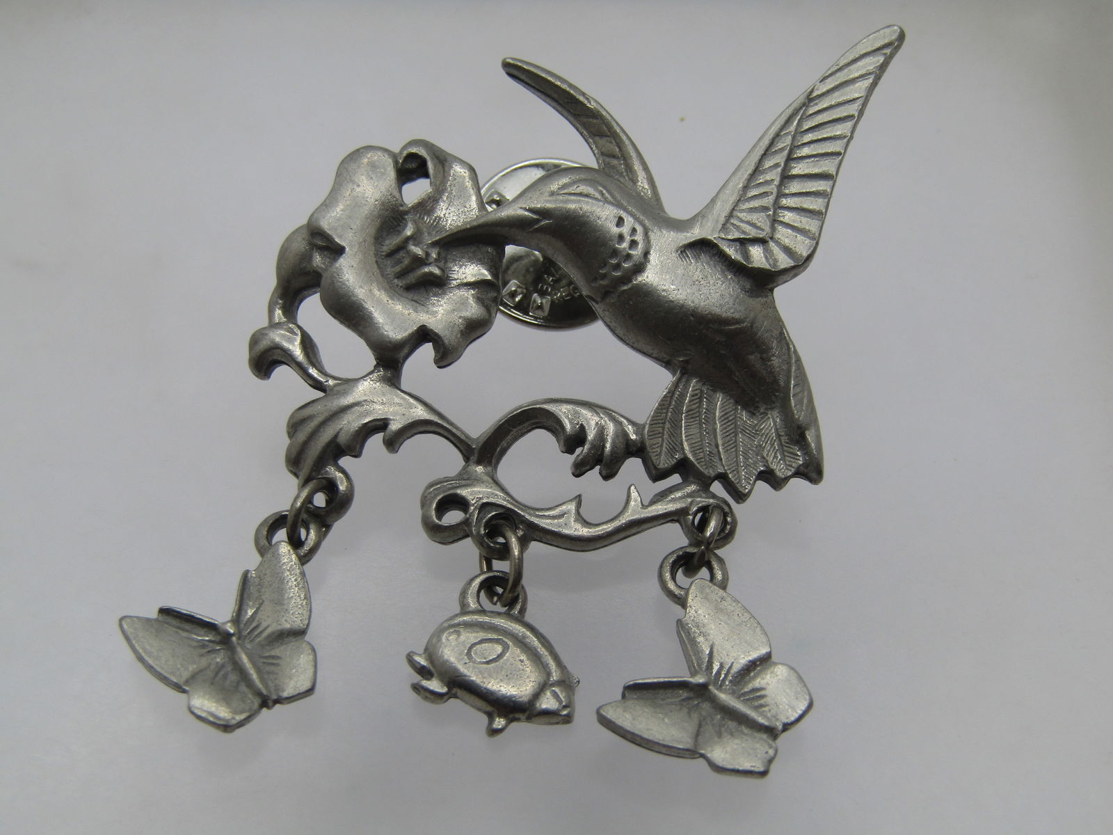 Vintage Hummingbird Floral, Butterfly & Ladybug Lapel/Tack Pin, Signed LCD, Pewter, 1980's-1990's: Vintage Hummingbird Floral, Butterfly & Ladybug Lapel/Tack Pin, Signed LCD, Pewter, 1980's-1990's. Pewter and appx. 2" tall and 1.25" wide. The hummingbird is getting a meal from a lily blossom and da